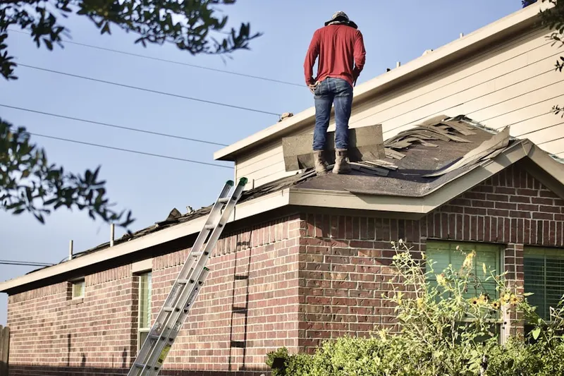 Professional roofer working on a residential roof in Guthrie